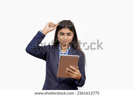 concept of distance learning. Happy Indian Asian Girl working on her tablet while studying online