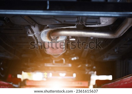 Close-up of catalytic converter in automobile exhaust system. Royalty-Free Stock Photo #2361615637