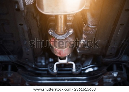 Close-up of catalytic converter in automobile exhaust system. Royalty-Free Stock Photo #2361615653