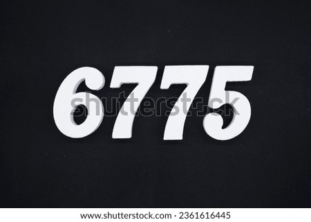 Black for the background. The number 6775 is made of white painted wood.