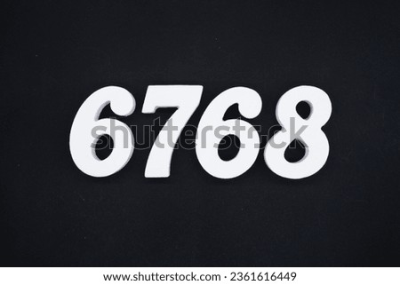Black for the background. The number 6768 is made of white painted wood.