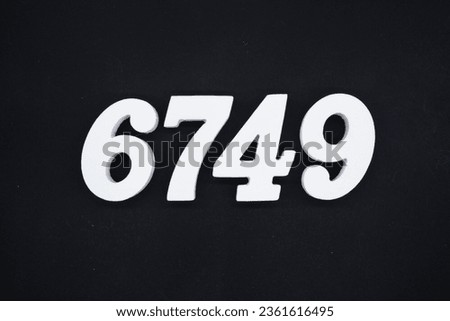 Black for the background. The number 6749 is made of white painted wood.