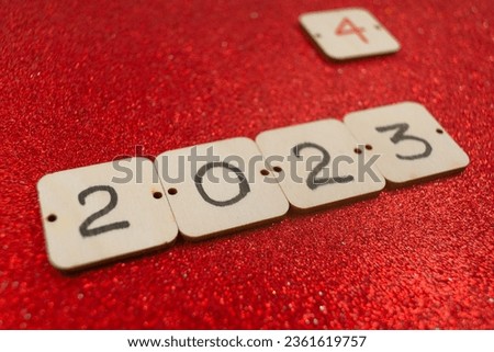 2023 ends, 2024 begins, inscriptions on wooden cards on a red background