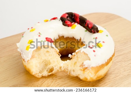 Image of donuts on wooden cutting board on brown sack background