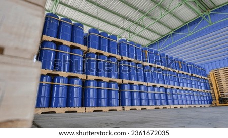 Chemical storage tanks neatly stored on wooden pallets in Warehouse. Warehouse management and industrial chemistry concept.