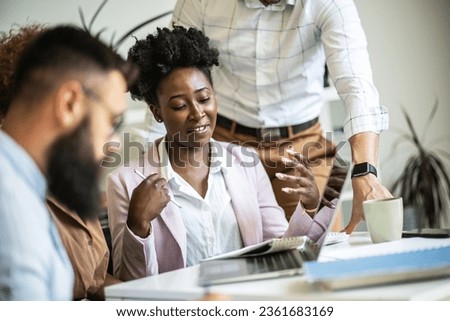 A diverse, casual design team collaborates in the office, creating innovative solutions and fostering in dynamic creative environment.	
 Royalty-Free Stock Photo #2361683169