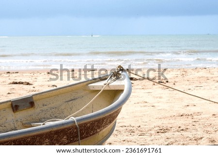 rustic fisherman's canoe at the seashore on the sands poetic image native brazilian ocean