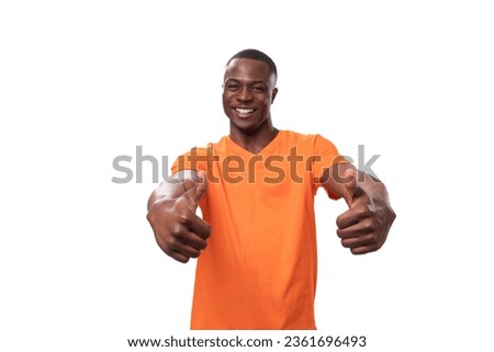 young charismatic strong african man in orange t-shirt isolated on white background with copy space