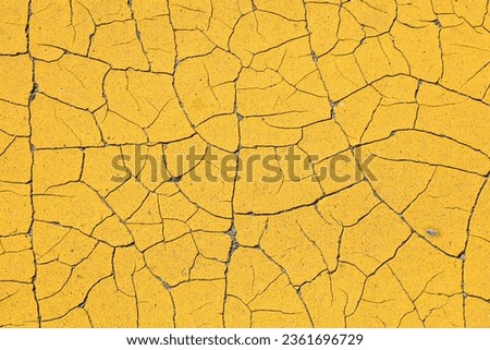 Yellow cracked paint distressed background. Grunge peeling paint texture.