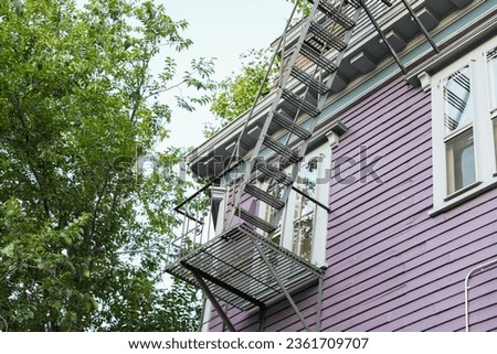 Emergency fire escape ladder hanging outside a home, vital for evacuation and safety during fires