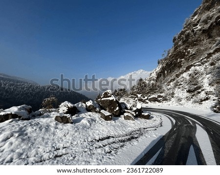 Mountain adventure landscape photo. Snowfall road. Snow time at the mountain picture. Rock hill.
