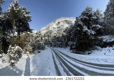 Mountain adventure landscape photo. Snow time at the mountain picture. Rock hill. Snowfall road. 