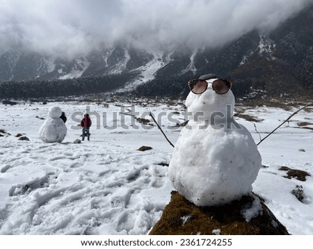 Snowman with sunglass. Mountain adventure landscape photo. Snow time at the mountain picture. 