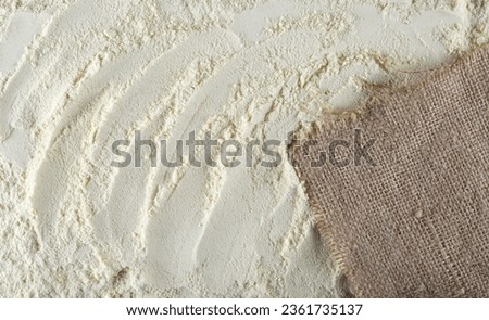 Millet flour and jute, linen sack background and texture Royalty-Free Stock Photo #2361735137