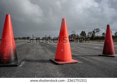 red cones in a row on an empty road