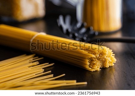 Spaghetti pasta. Uncooked italian pasta on a  black table. Royalty-Free Stock Photo #2361756943