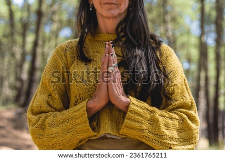 Close up of woman's clasping hands outdoors Royalty-Free Stock Photo #2361765211