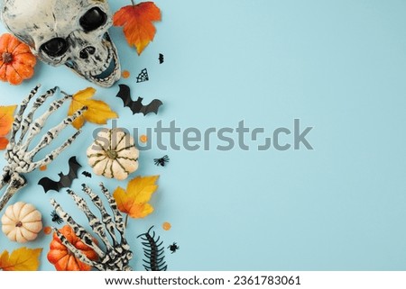 Partaking in the age-old rituals and customs of Halloween. Top view photo of skull, skeleton hands, colorful pumpkins, spooky insects, autumn leaves on light blue background with promo area
