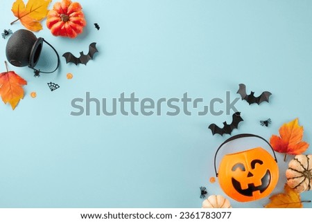 Connecting with the peculiar magnetism of the Halloween season. Top view shot of pot, halloween basket, spooky silhouettes, autumn leaves on light blue background with promo spot
