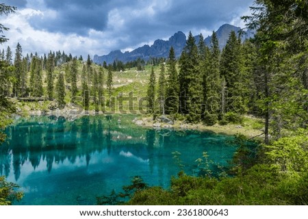 Blue lake in the Dolomites Italy, Carezza lake Lago di Carezza, Karersee with Mount Latemar, South tyrol, Italy.