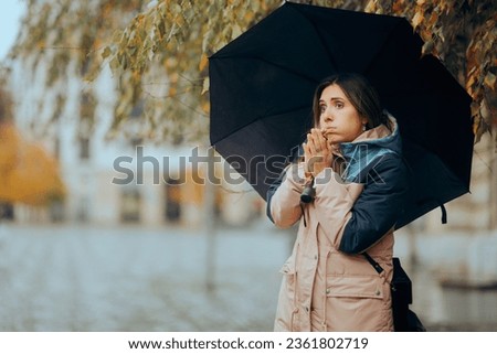 
Woman Rubbing Hands Feeling Cold in a rainy Day
Freezing person waiting outside in the rain for her date

 Royalty-Free Stock Photo #2361802719