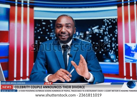 Host reveals famous couple divorcing on live television night show, presenter doing media reportage abut celebrities ending marriage in news studio. African american entertainment journalist.