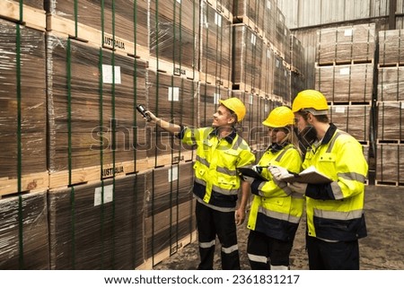 Wood factory worker men and woman team checking stack of inventory wooden stocks in wood distribution warehouse