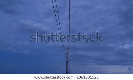 Picture of electric poles with cloudy sky