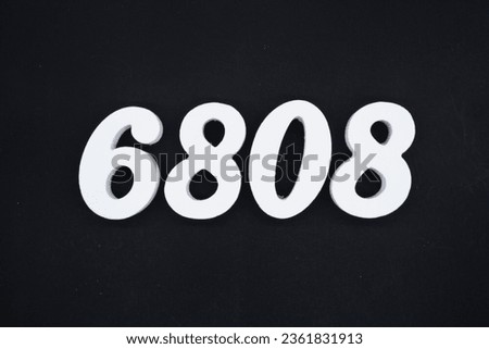 Black for the background. The number 6808 is made of white painted wood.