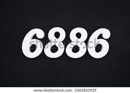 Black for the background. The number 6886 is made of white painted wood.