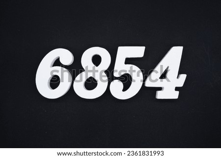 Black for the background. The number 6854 is made of white painted wood.