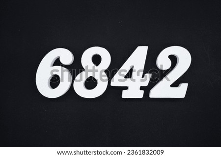 Black for the background. The number 6842 is made of white painted wood.