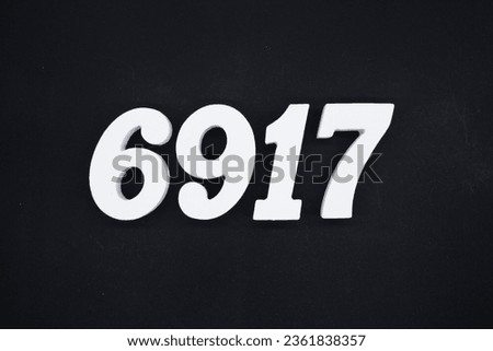 Black for the background. The number 6917 is made of white painted wood.