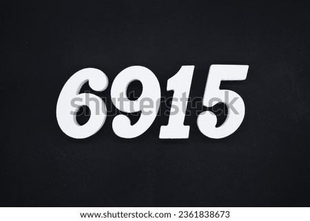 Black for the background. The number 6915 is made of white painted wood.