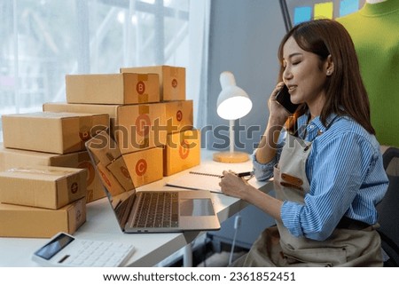 Small business start up, SME owner, female entrepreneur working on packaging parcel boxes, call, confirm order and verify online orders to prepare boxes for customers. SME business concept.