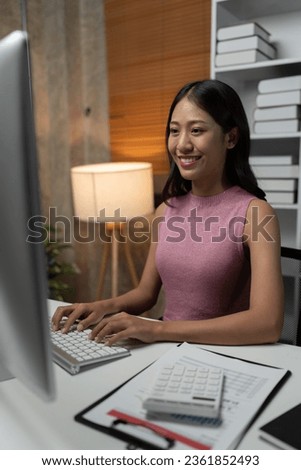 Asian businesswoman sitting working with desktop pc for finance, documents, accounting, tax, reports, marketing, growth statistics, business analytical research concept.