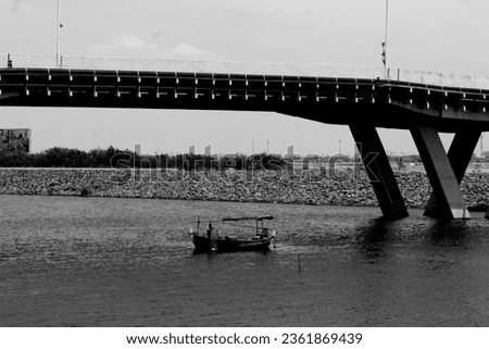 The concept image does not focus on the view of fishermen under the bridge in black and white, could be used for a magazine cover