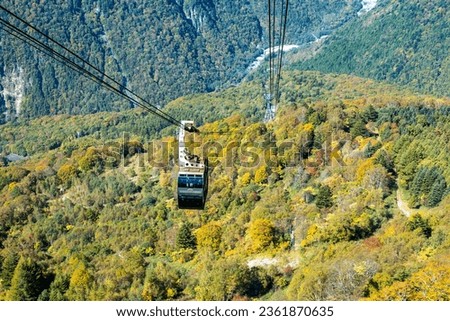The atmosphere of the main tourist attraction Shin Hotaka in the autumn colors with a cable car and ropeway serving tourists. Japan Alps, Shinhotaka Ropeway and Fall foliage. Royalty-Free Stock Photo #2361870635