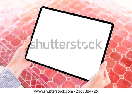 Person holding digital tablet, blank white screen mockup