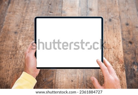 Person using digital tablet, blank white screen mockup