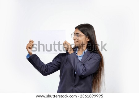 Beautiful youthful, cute, lovely Asian woman wearing glasses holding a white banner or blank board for advertising on a white background.