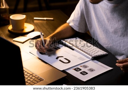 Asian man graphic designer working on computer drawing sketches logo design with mock-up text. The concept of a new brand. Professional creative occupation with idea.