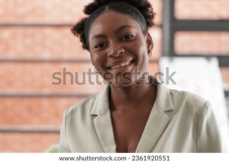 Portrait business african woman smiling and using smart mobile phone. headshot of an african american businesswoman.
