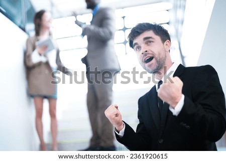 Businessman rejoicing for his success. worker smiling and screaming for success. Celebration concept. Cheerful  young businessman celebrating. manager in suit and tie raising hands up and screaming, 