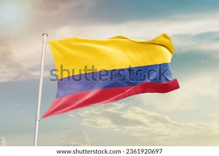 Colombia national flag waving in beautiful sky.