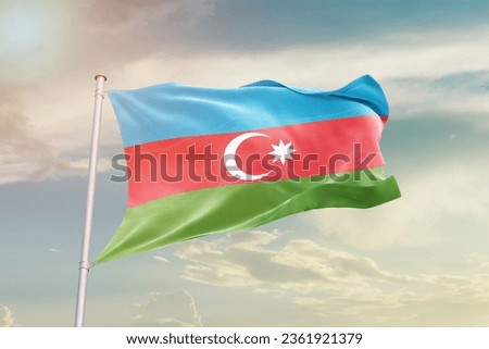 Azerbaijan national flag waving in beautiful sky. Royalty-Free Stock Photo #2361921379