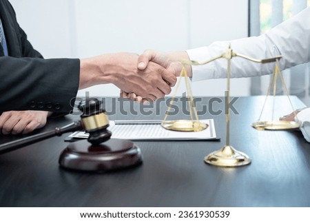 Male lawyer shaking hands with client after good deal negotiation cooperation meeting in courtroom.