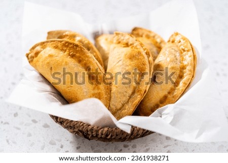 Freshly baked sweet cherry empanadas in the air fryer on the kitchen counter. Royalty-Free Stock Photo #2361938271