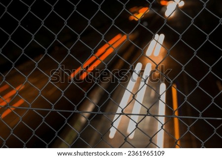 Photo Motion Blur Lights 
 Vehicle under an iron-fenced bridge, this photo was shot with a low shutter speed