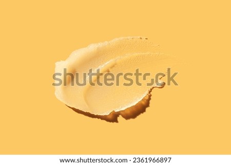 Cosmetic melon yellow balm or ointment or mask swatch on orange background Royalty-Free Stock Photo #2361966897
